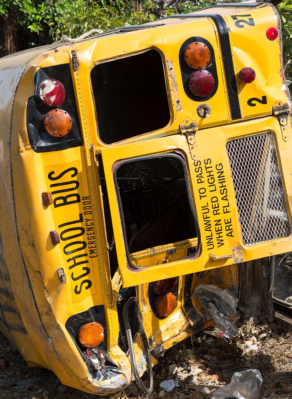 A crashed school bus laying on its side.